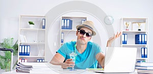 Businessman preparing for vacation in the office