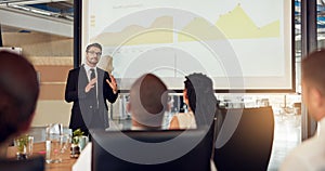 Businessman, presentation and meeting audience with graphs in boardroom for financial analysis, charts or report