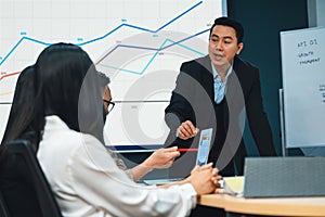 Businessman presenting financial plans to board in meeting room. Intellectual.