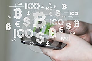 Businessman presses currencies button on phone ICO Initial Coin Offering on virtual electronic user interface account.