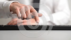 Businessman pressing a button on computer keyboard