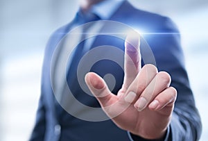 Businessman pressing button on virtual screen. Man pointing on futuristic interface.