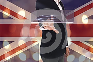 Businessman pressing button on virtual screens, blurred of British Flag and bokeh lights background