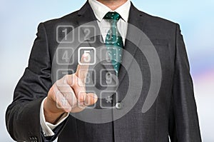 Businessman pressing numerical button on virtual touch screen