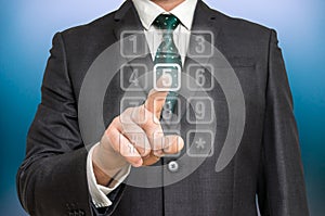 Businessman pressing numerical button on virtual touch screen