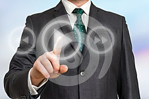 Businessman pressing play button on a virtual background