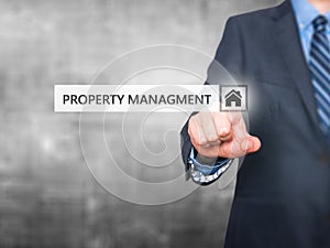 Businessman pressing property management button on virtual scre