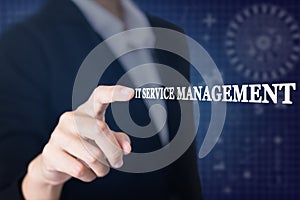 Businessman pressing a IT SERVICE MANAGEMENT concept button.