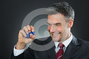 Businessman Pressing Stressball In Hand