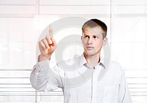 Businessman pressing a touchscreen button