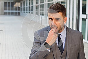 Businessman pretending to puke in office space