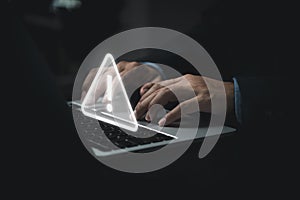 Businessman programmer, developer using laptop computer with triangle caution warning sign for notification error and maintenance