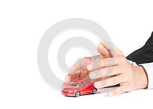 Businessman protect with his hands a red car, car insurance concept