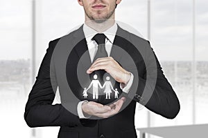 Businessman protecting family