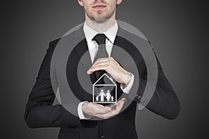 Businessman protecting family home