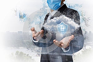 Businessman in protective mask shows clouds secured in the network connections