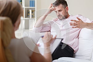 Businessman on psychotherapy session photo