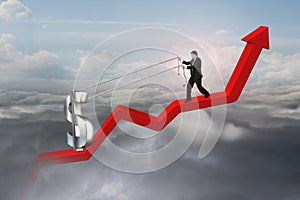 Businessman pulling 3D dollar sign upward on red trend line