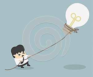 Businessman pulling bulb with rope