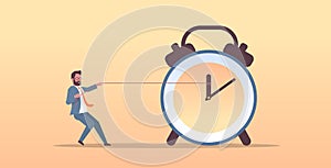 Businessman pulling clock arrow deadline time management concept business man in suit pushing back hour hand horizontal