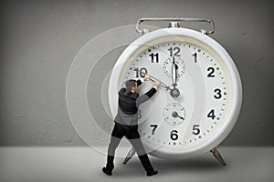 Businessman pulling a clock hand