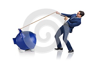 The businessman pulling piggybank with rope