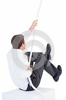 Businessman pulling a rope with effort