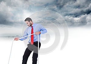 Businessman pulling rope in sky