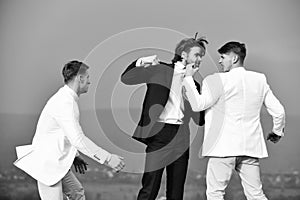 Businessman punching, hitting colleague, twin men in formal outfit