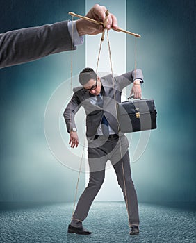 Businessman puppet being manipulated by boss