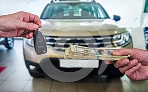 Businessman purchase new car in showroom giving dollars money and taking keys from car