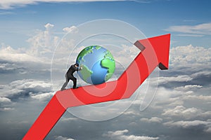 Businessman push globe upward on red trend line