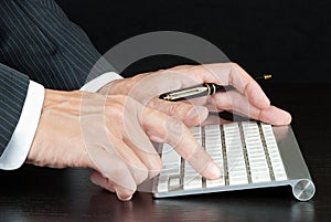 Businessman Pushes Enter On Computer Keyboard