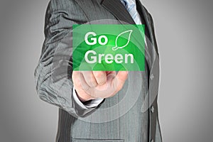 Businessman pushes touch screen go green button