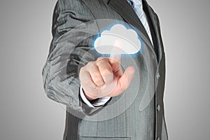 Businessman pushes virtual cloud button