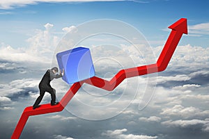 Businessman pushing blue 3D block upward on red trend line