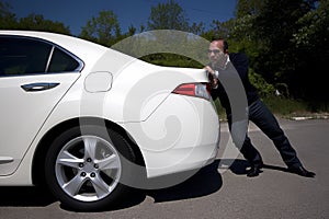 Businessman pushing a car