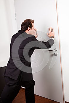 Businessman pushing the door