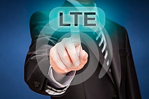 Businessman pushing finger on lte button