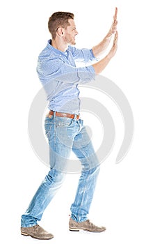 Businessman pushing invisible wall against white background