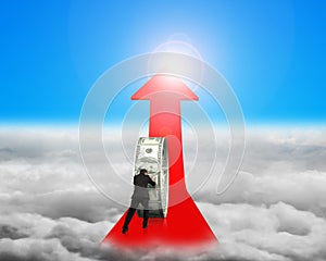 Businessman pushing money circle on red arrow with sunlight cloudscape