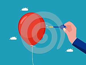 Businessman pushing a needle to poke a balloon. business risk concept or dangerous situation