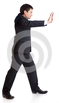 Businessman is pushing something