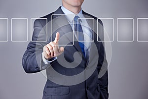 Businessman pushing on a touch screen interface
