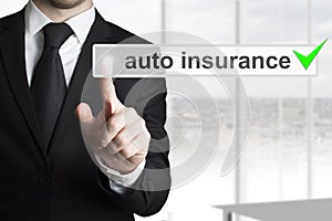 Businessman pushing touchscreen button auto insurance