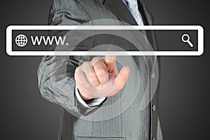 Businessman pushing virtual search bar on black background