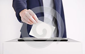 Businessman Putting a Ballot into a Digital Tablet. Voting Online