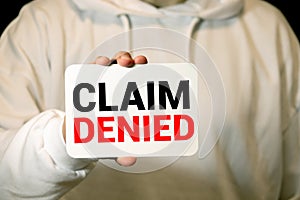 Businessman putting a card with text Claim Denied