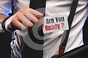 Businessman putting a card with text Are You Ready