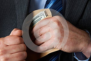 Businessman Putting Envelope of Dollars In Pocket